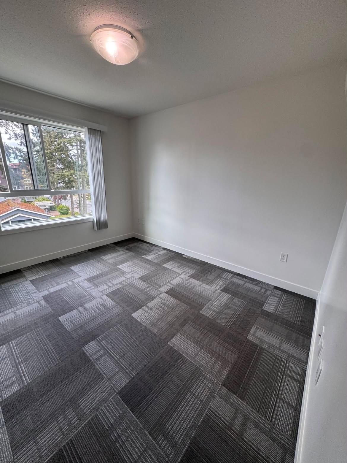 Empty carpeted room after a move-out clean