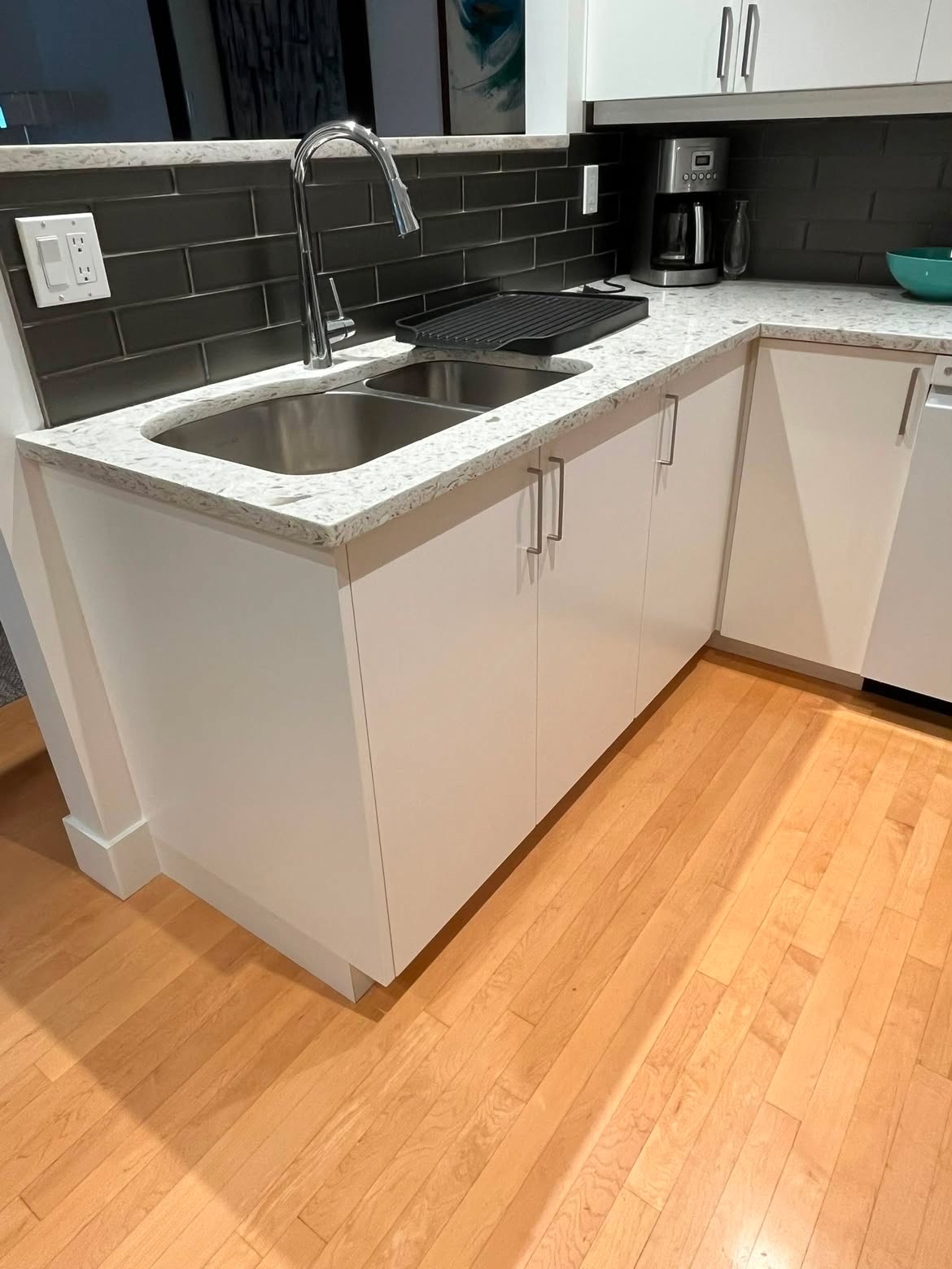 Kitchen corner after a clean — sink, counters, and backsplash
