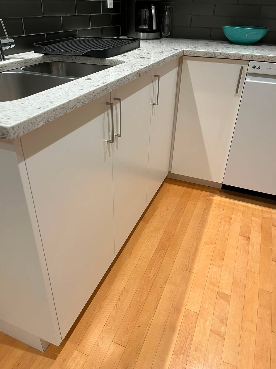 Clean kitchen sink, counters, and cabinets