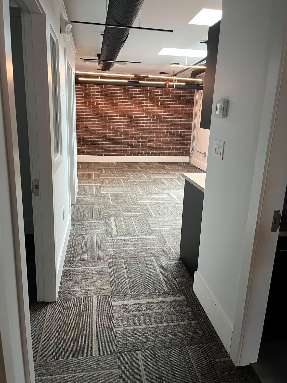 Clean commercial hallway with brick feature wall